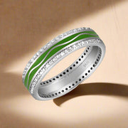 A 925 sterling silver ring with green and silver colors and embedded with cubic zirconias.